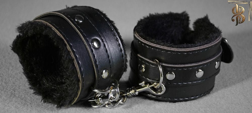 pair of bondage handcuffs in black leather