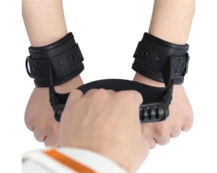 two hands attached with handcuffs and one hand holding the handle.